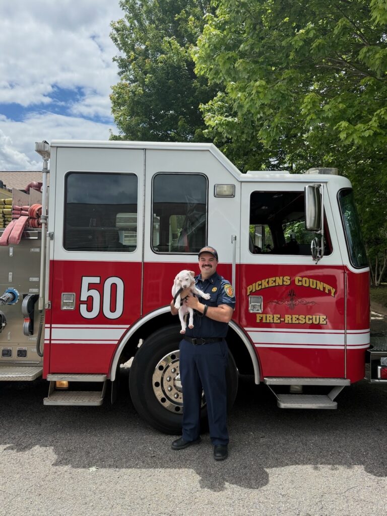 Lt. Holaway and Lt. Pee Wee in front of a fire truck.
