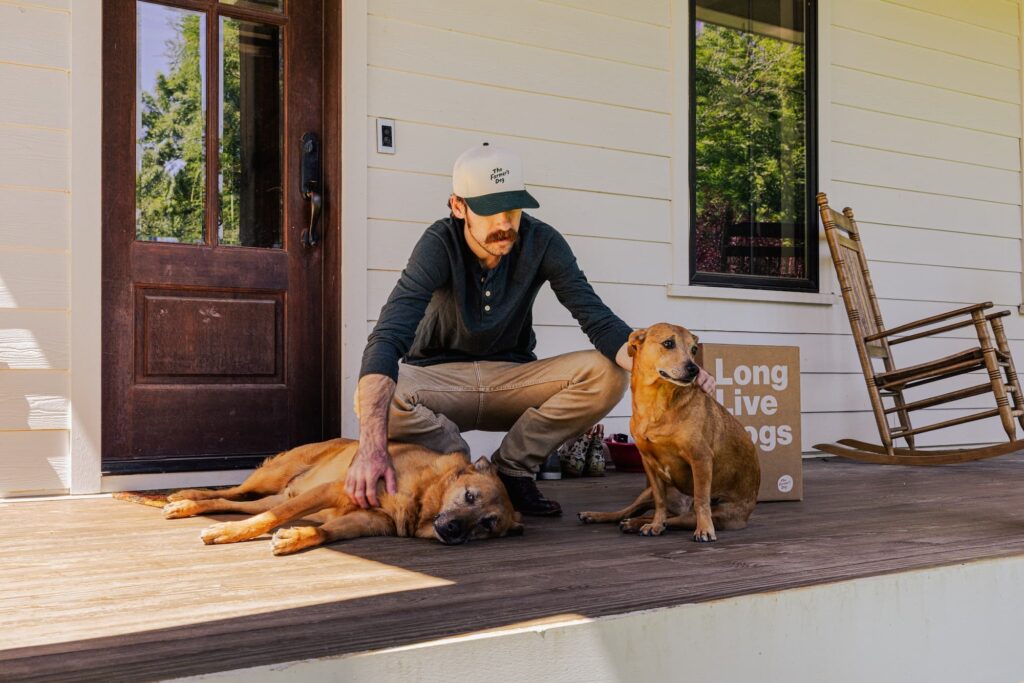 Ryan Blaney petting dogs on his porch.
