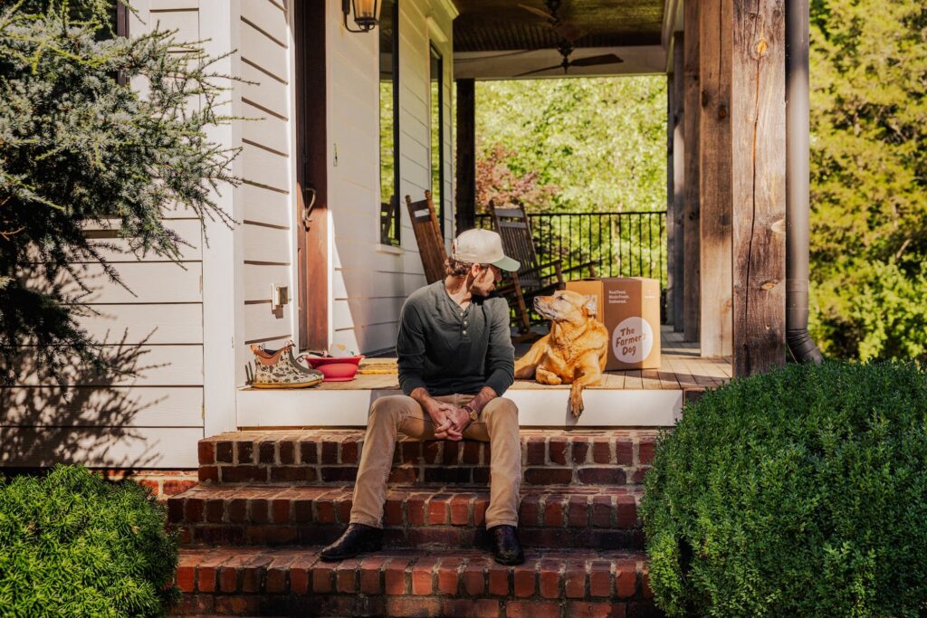 Ryan Blaney on his porch looking at his dog Sturgill.