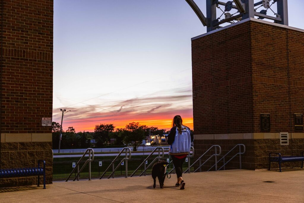 Victoria and Mokoro walking the ballpark concourse at sunset.