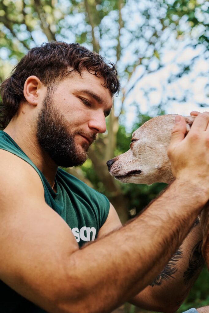 Cam Skattebo petting Duke.